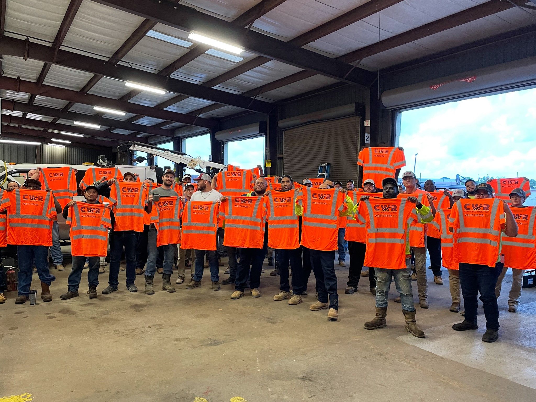 Workers with CWR Contracting show off their Watch For Us PPE.